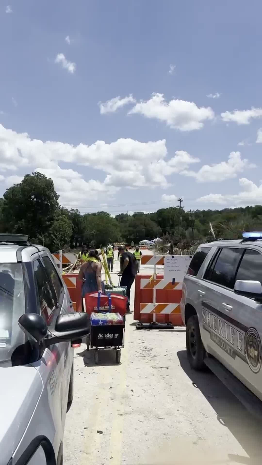 Supplies wheeled in past emergency vehicles