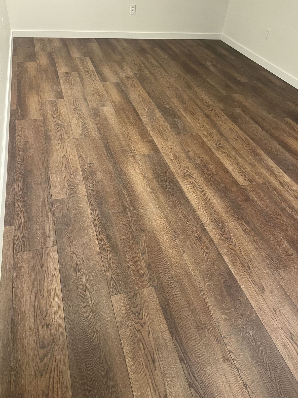 Dark oak vinyl plank installed by 254 Floors