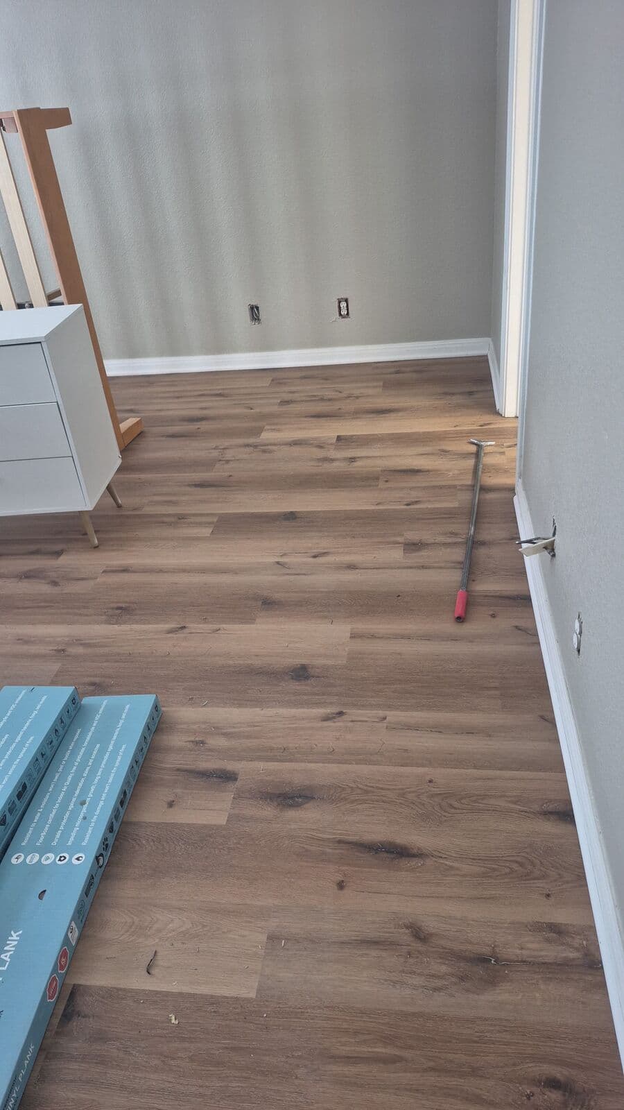 Brown oak vinyl plank after tile removal