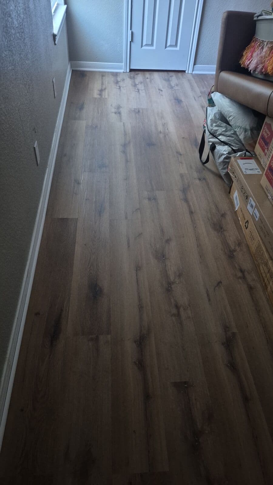 Brown oak vinyl plank after tile removal