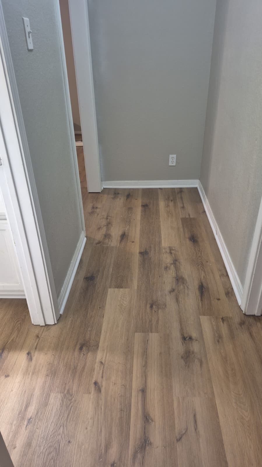 Brown oak vinyl plank after tile removal