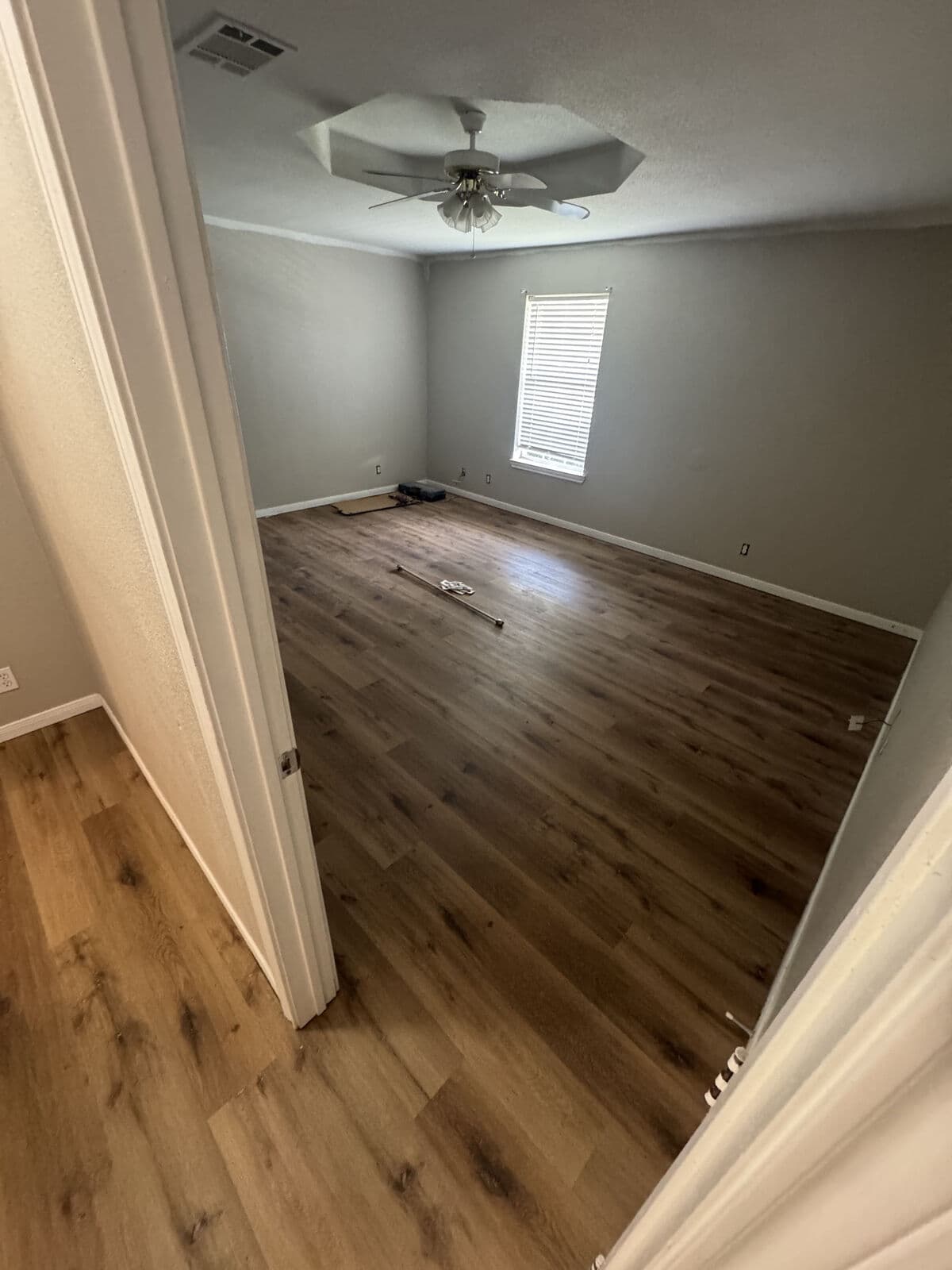 Brown oak vinyl plank after tile removal