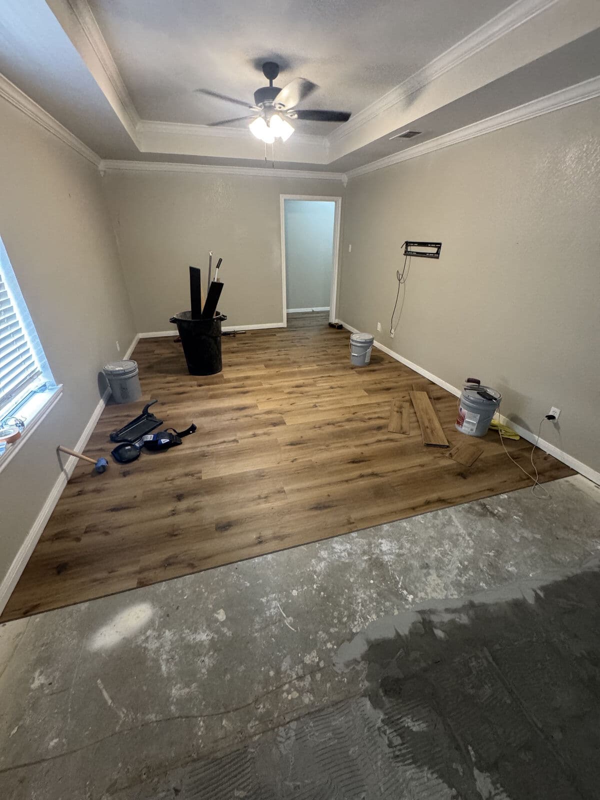Brown oak vinyl plank after tile removal