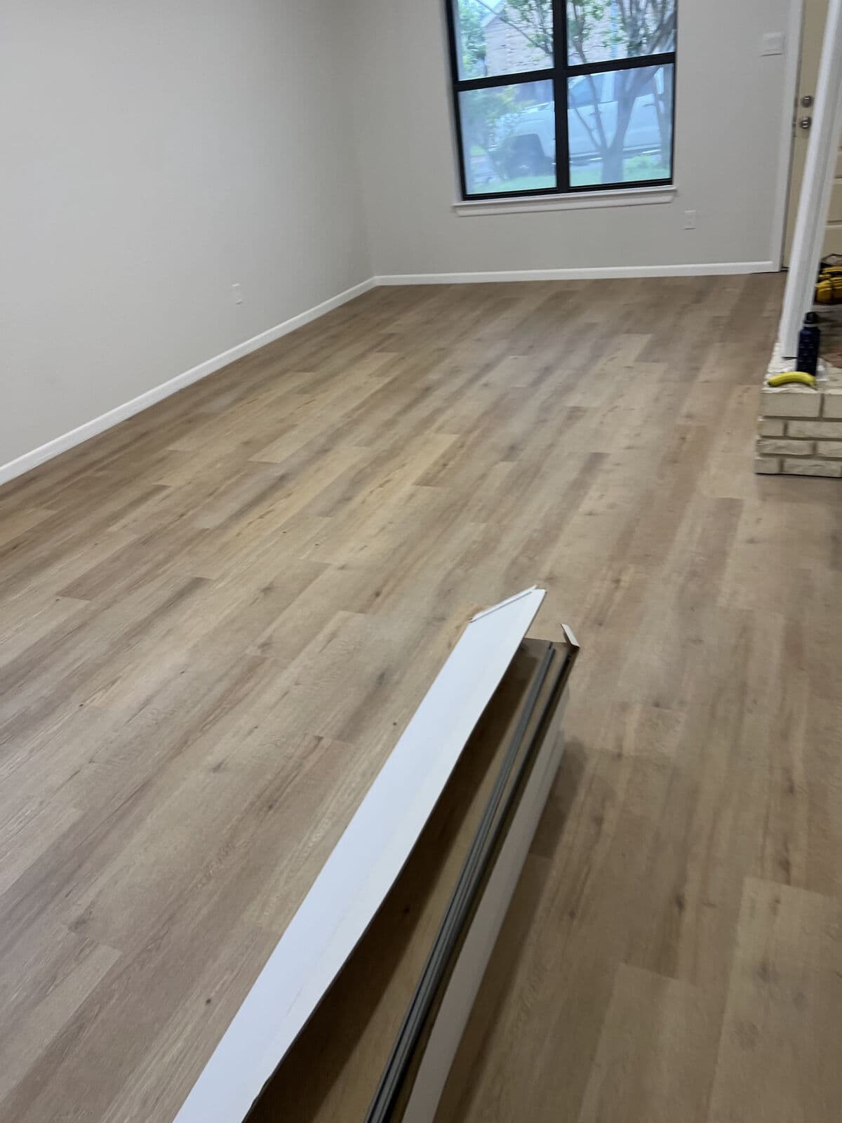 Brown oak vinyl plank after tile removal