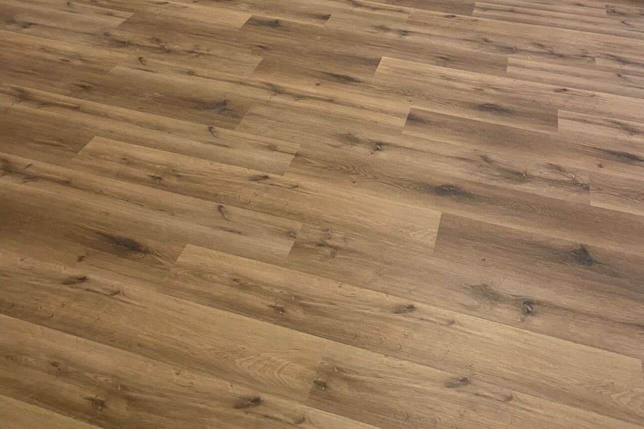 Brown oak vinyl plank after tile removal