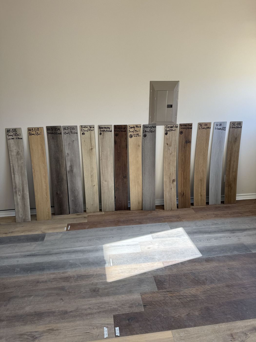 Full-size vinyl plank samples lined up at the Liberty Hill showroom